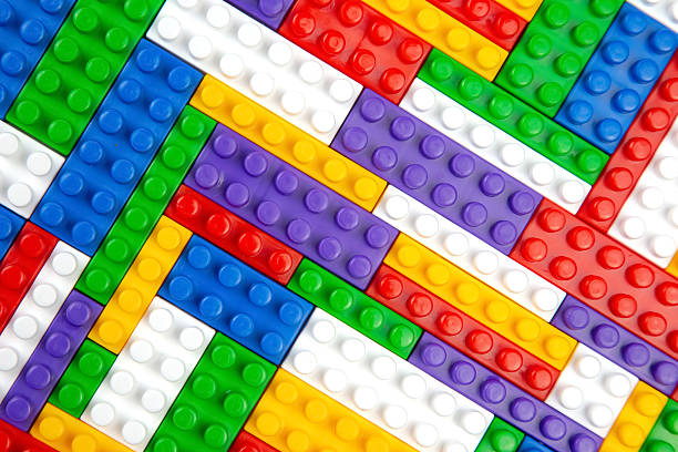 Abstract background texture of colored constructor blocks. Background of colorful plastic part of constructor. Pile of colored toy bricks.