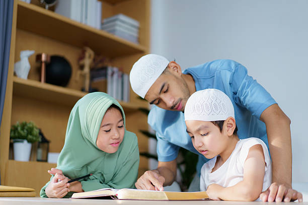 istock Man is teaching homework for his children. 2208666964