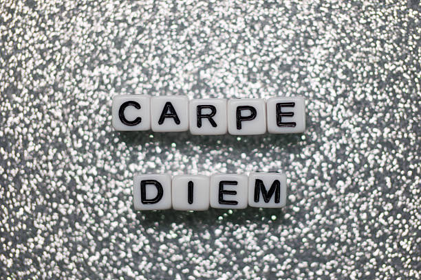 Letter blocks spell out the phrase Carpe Diem against a sparkling background, encouraging spontaneity and seizing the day. The arrangement shines with positivity and inspiration.
