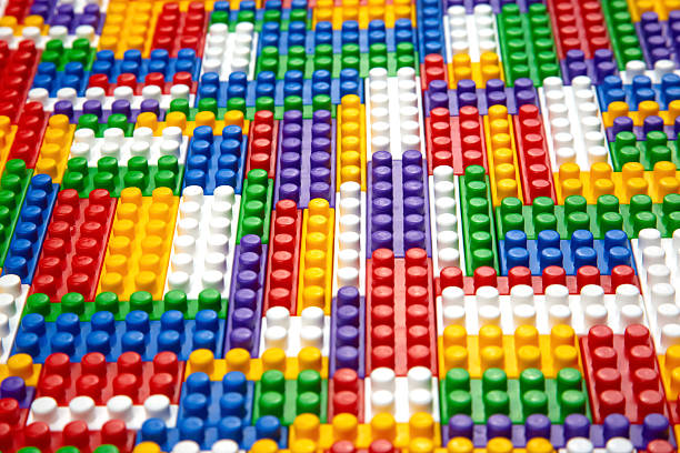 Abstract background texture of colored constructor blocks. Background of colorful plastic part of constructor. Pile of colored toy bricks.