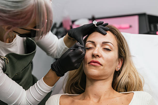 istock Beautician applying permanent eyeliner makeup to a client 2208669979