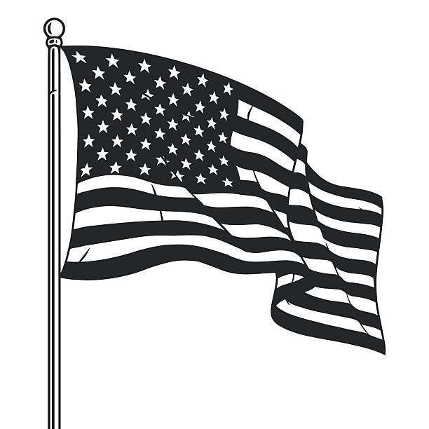A black and white representation of the American flag is flying from a pole. The stars and stripes are displayed prominently creating a dynamic sense of movement.