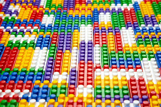 Abstract background texture of colored constructor blocks. Background of colorful plastic part of constructor. Pile of colored toy bricks.