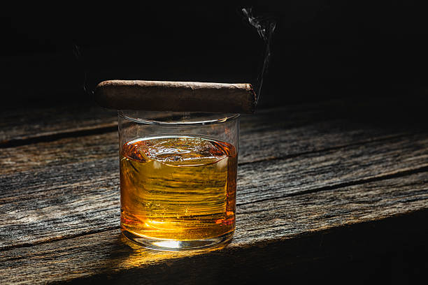 istock Bourbon in a glass on old wood table 2208674439