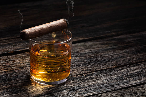 istock Bourbon in a glass on old wood table 2208674440