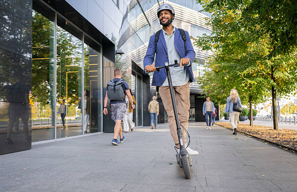 istock Well-dressed Man Riding Electric Scooter 2208676206