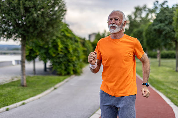 istock Senior man jogging in a park maintaining a healthy lifestyle 2208679029