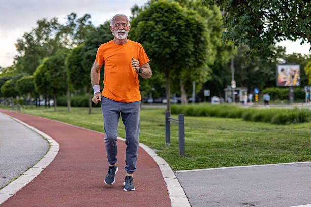 istock Senior man jogging in a park, maintaining a healthy lifestyle 2208679058
