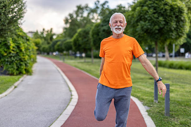 istock Senior man stretching legs before running in a city park 2208679079