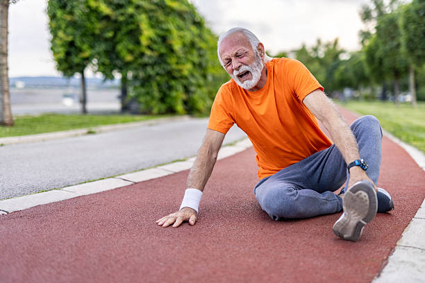 istock Senior man experiencing foot pain while jogging outdoors 2208679126