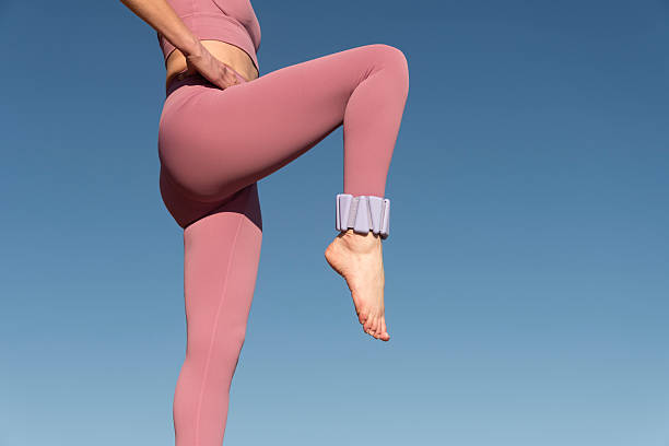 istock sporty woman with adjustable ankle weights working out 2208681458