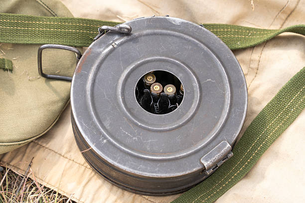istock WWII Soviet PPS submachine gun with visible drum magazine and bullets on military canvas 2208681623