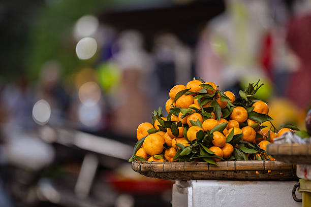 Group of orange fruits on market stall at local green grocery.