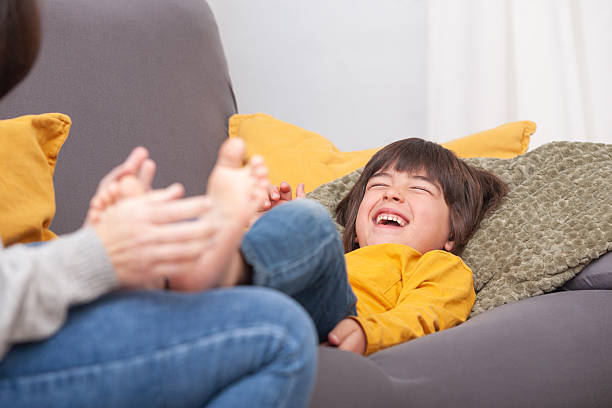 istock Giggles and tickles – barefoot child with smiling face 2208684411