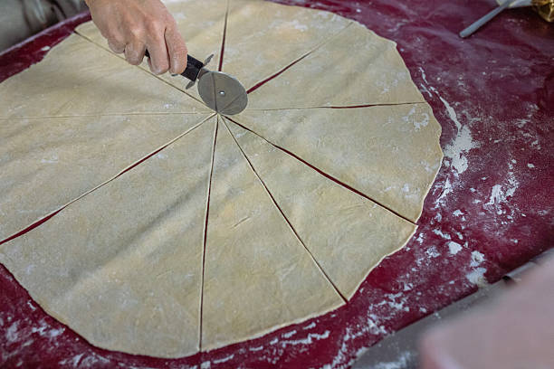 istock Close-up of unrecognizable woman spreading dough while preparing it for cutting out 2208685333
