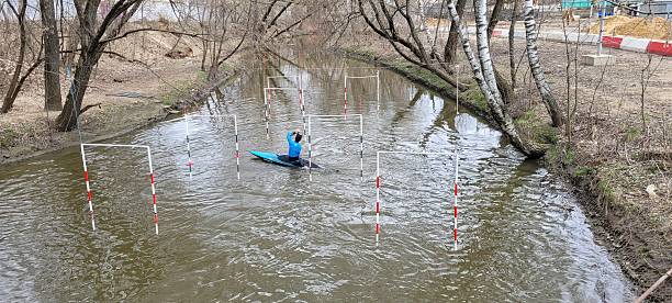 Moscow, Russia - April, 05, 2025.An athlete trains in a kayak for canoe slalom on the Yauza River in Moscow.