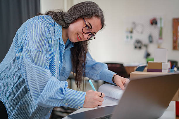 istock Entrepreneur Writing on Document for Business Management 2208690236