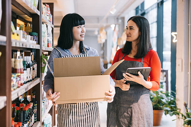 istock Two women working together in the organic store, using a tablet to update inventory 2208691094