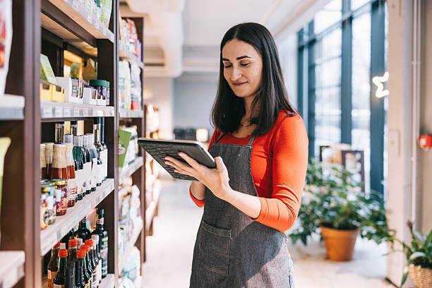 istock Female store worker uses a digital tablet to check inventory in the store 2208691117