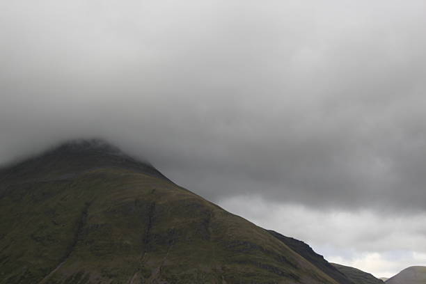 istock A mountainpeak in the clouds on a cloudy day 2208691257