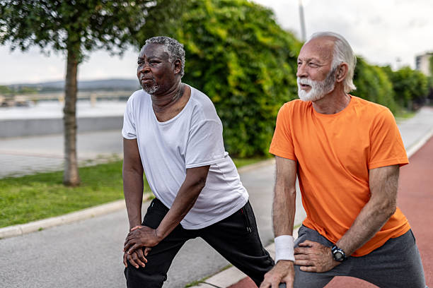 istock Two senior men stretching legs before exercising outdoors 2208692257