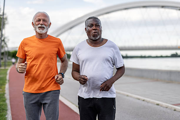 istock Two senior men are jogging near the river 2208692359