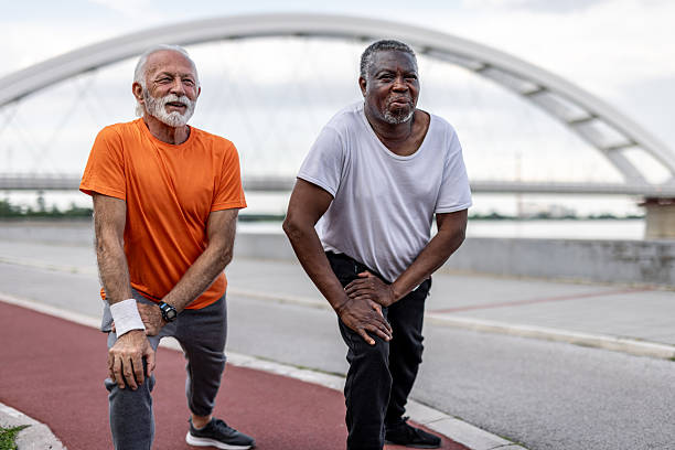 istock Two senior men stretching legs before exercising outdoors 2208692366