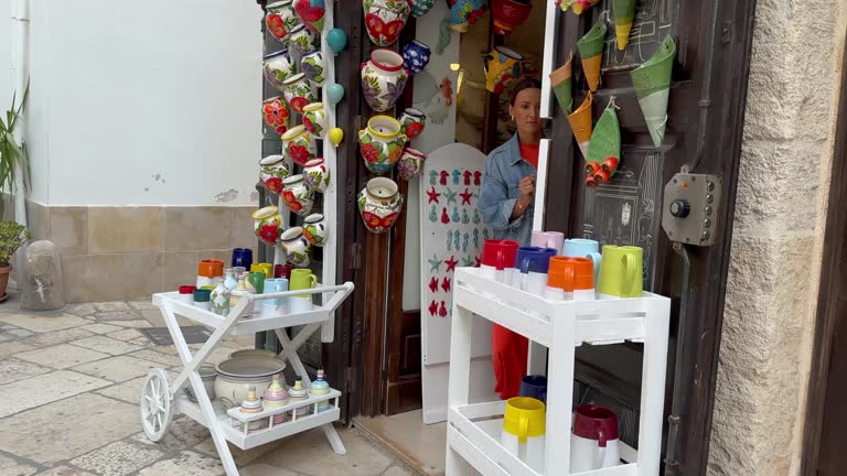 Polignano a Mare, Italy - September 16, 2024: Tourists walk and enjoy downtown of Polignano a Mare, Italy, a town in Metropolitan City of Bari, Apulia, southern Italy, located on the Adriatic Sea