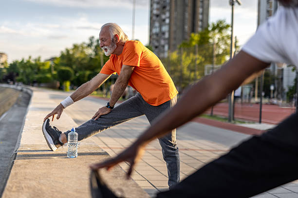 istock Senior man stretching legs after working out outdoors 2208692561