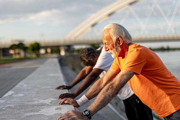istock Senior men stretching after working out outdoors 2208692588
