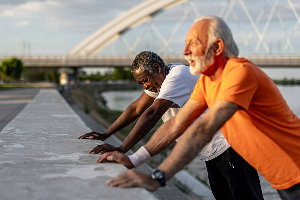 istock Two senior men stretching after working out outdoors 2208692599