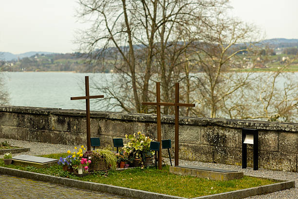 The Rosengarten cemetery is a cemetery in Aarau. It is located in the Zelgliquartier south of the old town. The crematorium located in the middle of the cemetery is listed as a cultural asset of national importance. The image shows several graves captured on a cloudy day during spring season.