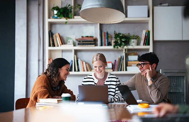 istock Group of Students Collaborating in a Cozy Modern Library Setting 2208695133