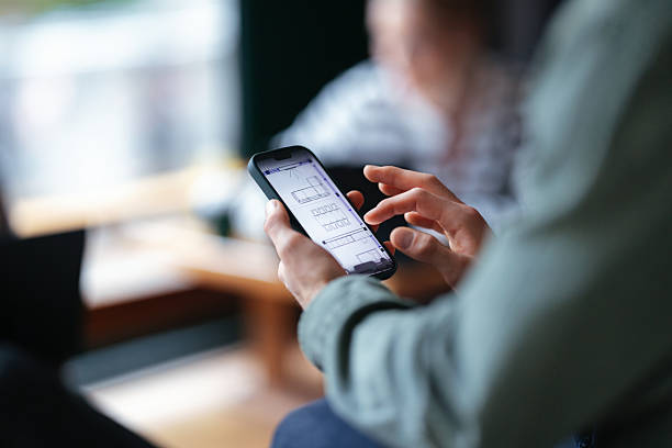 istock Student on Smartphone Reviewing Diagrams Inside a Cozy Cafe Setting 2208695169