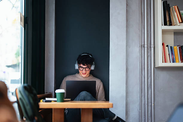 istock Student Working on a Laptop in a Cozy Library Cafe Setting 2208695172
