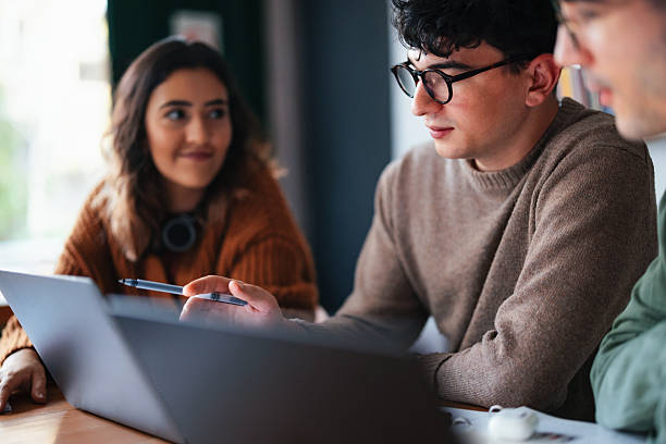 istock Group of Students Studying Together in a Cafe Setting 2208695704