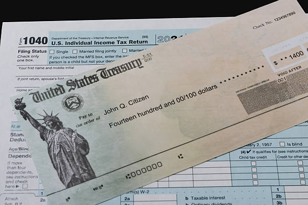istock IRS refund check and tax form in close up view 2208697678