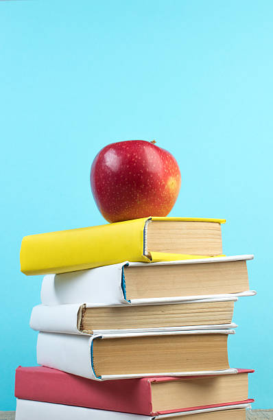 istock Books stacking. Books on wooden table and blue background. Back to school. Copy space for ad text. 2208697880
