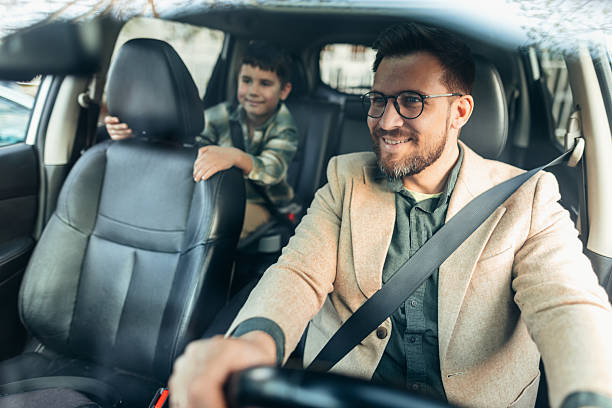 istock Father and son driving in car wearing seatbelts 2208700191