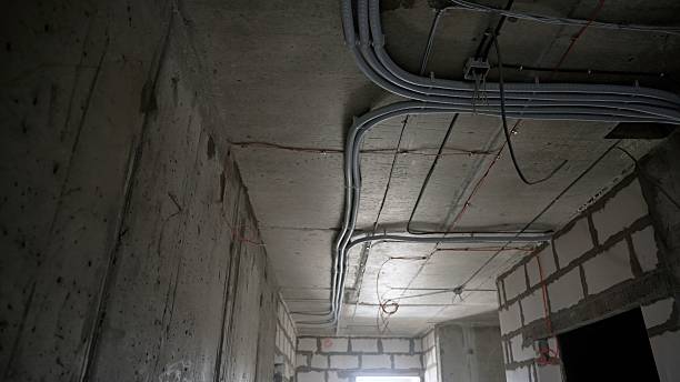 istock Electrical conduit wiring installation in building under construction 2208704835
