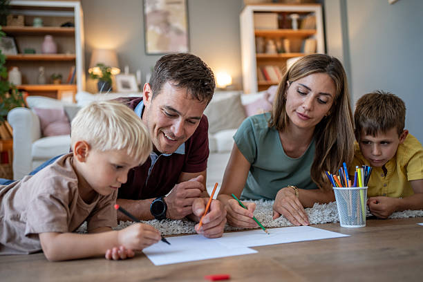 istock Happy family lying on floor drawing with colored pencils 2208711593