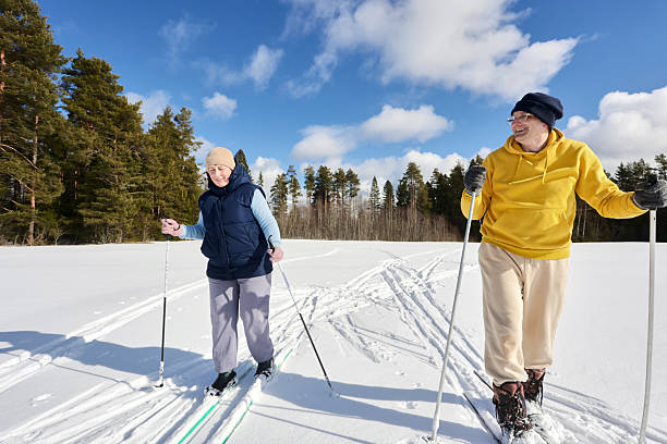 istock Cheerful Caucasian couple on ski trip in pine forest area. 2208717232