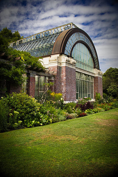 istock Lush Glass Conservatory in a Botanical Garden 2208718585