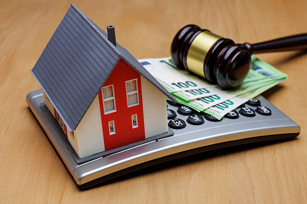 istock Model House, Banknotes and Gavel on Calculator 2208718620