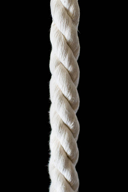 istock Strong, intertwined rope on black. A metaphor for connection, strength, or constraint. Ideal for themes of teamwork, reliability, and challenges. 2208725811