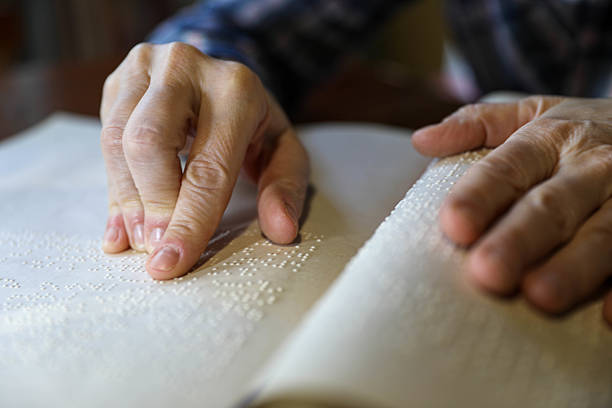 istock Blind Woman Over 50 Reading Braille Book 2208726286