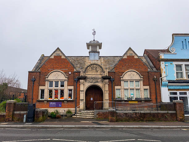 A brick building with a clock tower and a sign that says 