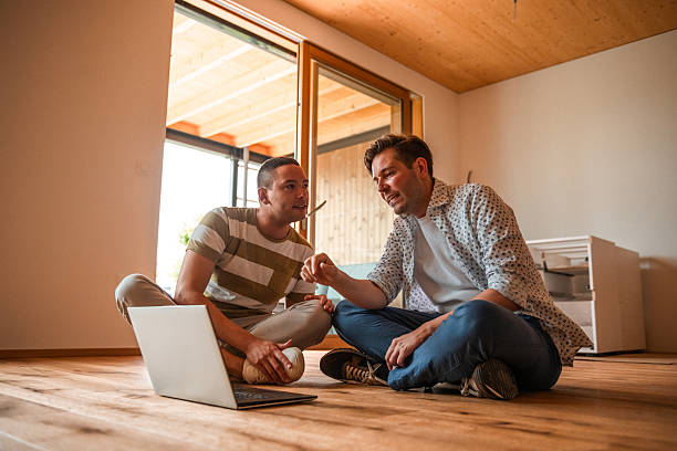 Professionals Reviewing 3D Renovation Designs on Laptop