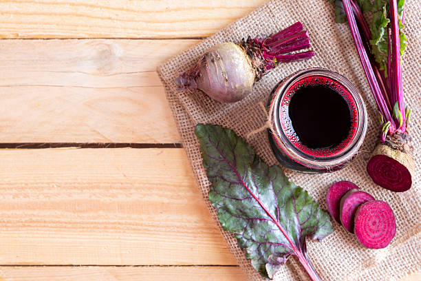 Freshly made beet juice on wood table. Space for text