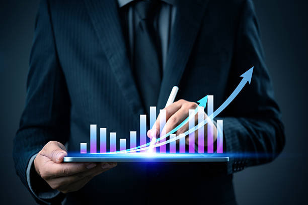 istock businessman using a tablet to analyze financial marketing growth, with a rising bar chart and arrows representing business success and data analysis. 2208756918